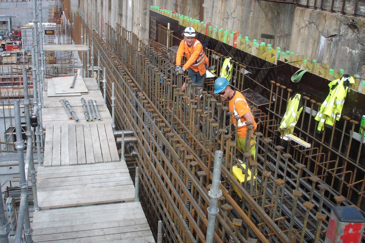 hrc-projects-two steel fixers looking at reinforcement with many headed bars